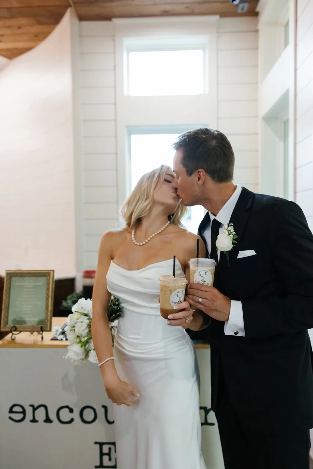 Newlyweds beside the Encounter Coffee cart at their Fort Worth wedding