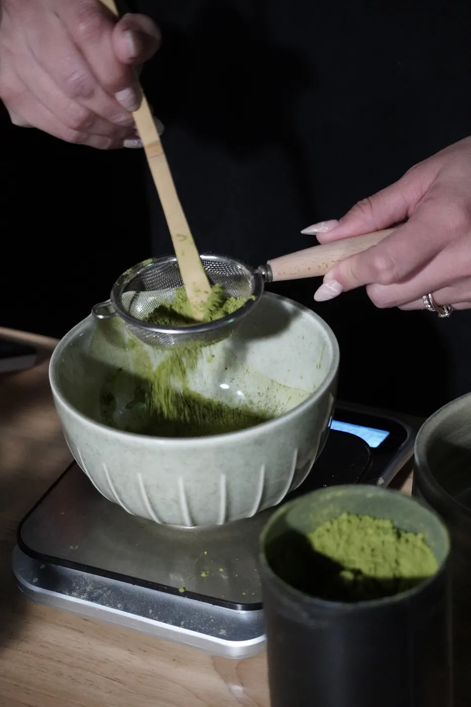 Ceremonial-grade matcha being sifted into a bowl before whisking at an Encounter Coffee event
