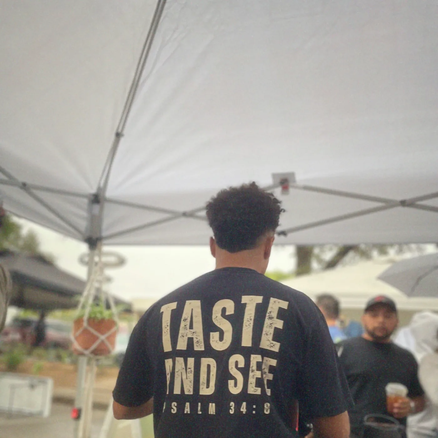 Encounter Coffee serving under a tent at a North Texas market, wearing a Taste and See shirt