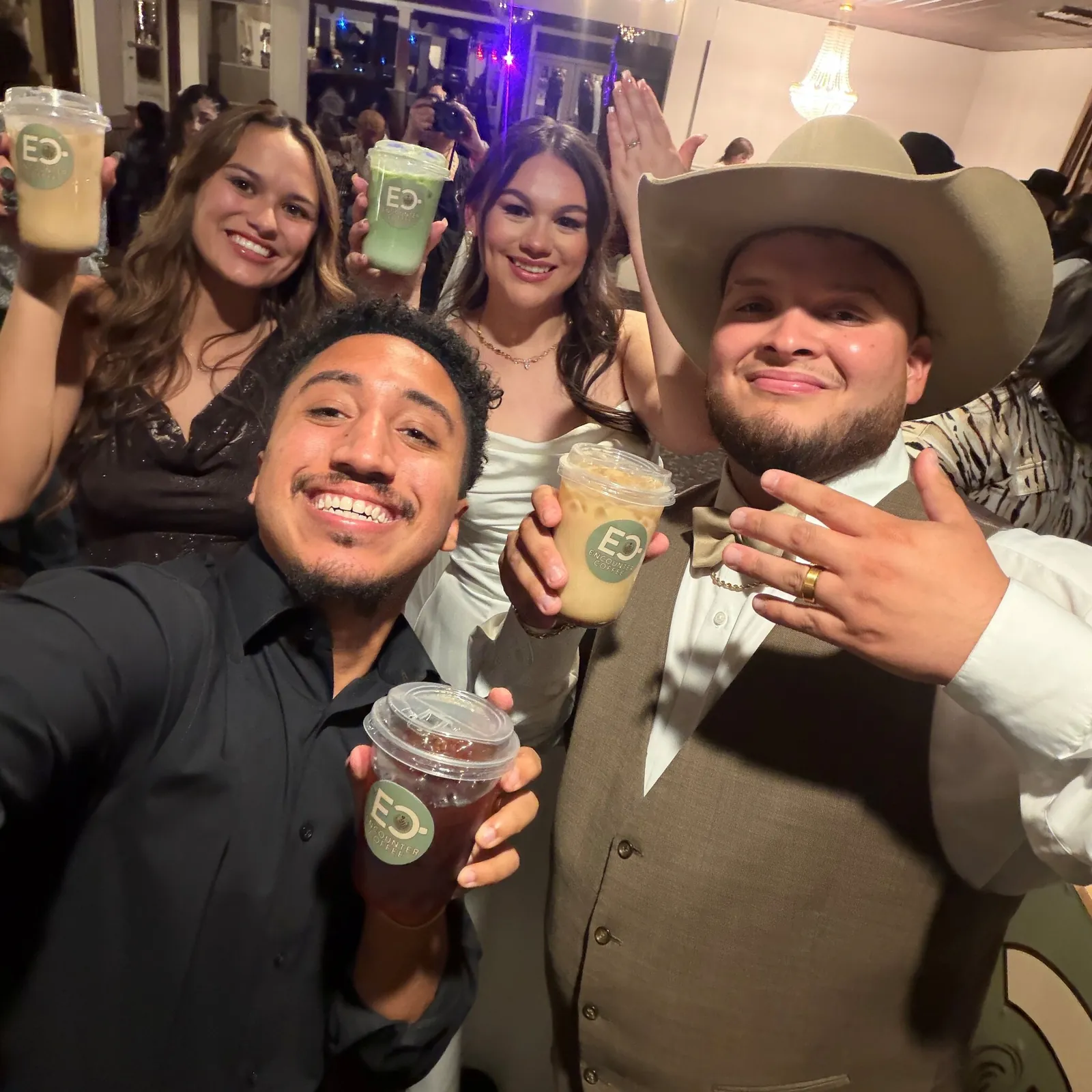Wedding guests raising Encounter Coffee cups with the bride and groom at a Dallas–Fort Worth reception
